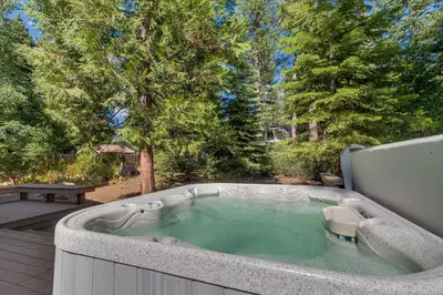 a jacuzzi tub in a yard with trees at High Sierra at Dollar Point - Private Hot Tub, Close to Ski Resorts, Pet Friendly! in Tahoe City