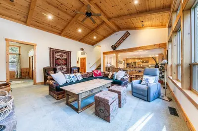 a large living room with a table and chairs at Indian Hills at Northstar by Tahoe Getaways - Spacious 4 BR, Private Hot Tub, Wood Fireplace, and HOA Amenities in Truckee