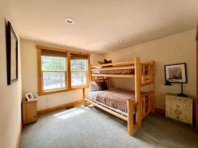 a bedroom with a bunk bed and a window at Indian Hills at Northstar by Tahoe Getaways - Spacious 4 BR, Private Hot Tub, Wood Fireplace, and HOA Amenities in Truckee