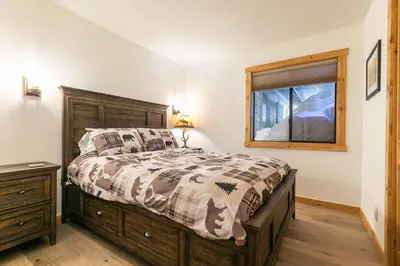 a bedroom with a bed and a window at Kokanee at Tahoe Donner - Charming 3 BR - Pool Table - Fireplace - Amenity Access! in Truckee