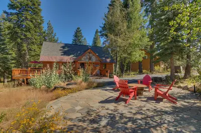 a house with red chairs and a table in front of it at Lazy Bear in Tahoe City