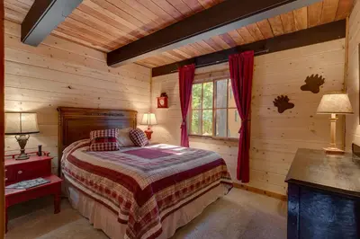 a bedroom with a bed in a log cabin at Lazy Bear in Tahoe City