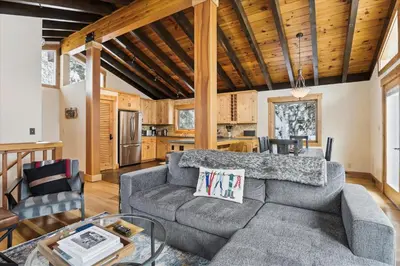 a living room with a couch and a table at Mariposa Heights at Alpine - Ski Shuttle to Slopes- Fireplace- Forest Views in Alpine Meadows