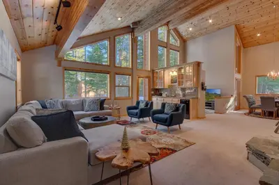 a living room with a lot of windows at Matterhorn at Tahoe Donner 3000 Sqft 4 BR with Private Hot Tub and HOA Pool, Gym and Beach Access in Truckee