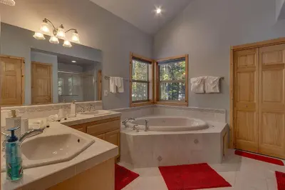 a large bathroom with two sinks and a tub at Matterhorn at Tahoe Donner 3000 Sqft 4 BR with Private Hot Tub and HOA Pool, Gym and Beach Access in Truckee