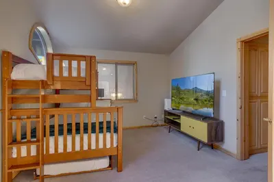 a bedroom with a bunk bed and a television at Matterhorn at Tahoe Donner 3000 Sqft 4 BR with Private Hot Tub and HOA Pool, Gym and Beach Access in Truckee