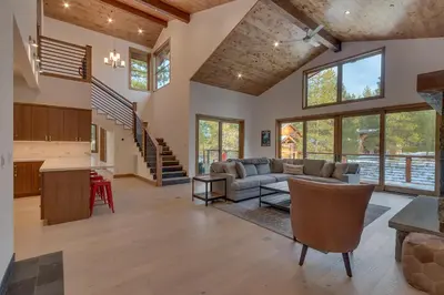 a living room with a couch and a table at Meek Court at Grays Crossing - Modern Luxury with Private Hot Tub in Truckee