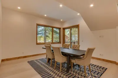 a dining room with a table and chairs at Meek Court at Grays Crossing - Modern Luxury with Private Hot Tub in Truckee