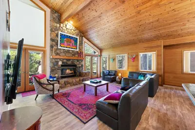 a living room with a couch and a fireplace at Mosaic Magic at Northstar - Luxury 4BR with Private Hot Tub and Free Ski Shuttle in Truckee