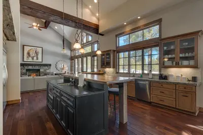 a large kitchen with a large island in the middle at Mountain Majesty at Grays Crossing - Luxury 4BR 4BA w Private Hot Tub in Truckee
