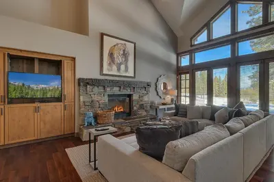 a living room with a couch and a fireplace at Mountain Majesty at Grays Crossing - Luxury 4BR 4BA w Private Hot Tub in Truckee