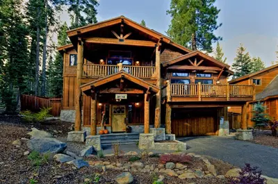 a large wooden house with a large deck at Olive Branch - Private Hot Tub, Media Room, Pet-Friendly, Near Northstar! in Carnelian Bay