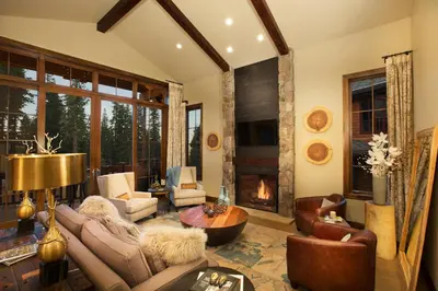 a living room with a couch and a fireplace at Mountainside by Tahoe Getaways - Luxury Pet-Friendly Northstar Ski-in Ski-Out - Swimming Pool and Gym! in Truckee