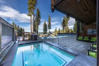 a swimming pool in a house with a building at Mountainside by Tahoe Getaways - Luxury Pet-Friendly Northstar Ski-in Ski-Out - Swimming Pool and Gym! in Truckee