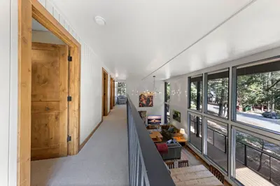 a hallway of a house with a staircase and windows at Ellis Peak Retreat - Hot Tub, Wood Fireplace, Close to Tahoe City & Dining in Tahoe City