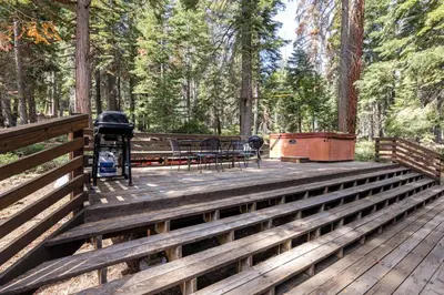 a wooden deck with a grill and a picnic table at Ellis Peak Retreat - Hot Tub, Wood Fireplace, Close to Tahoe City & Dining in Tahoe City