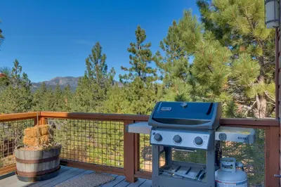 a blue grill on a deck with trees at Pinnacle Views at Tahoe Donner - 4BR, Hot Tub in Truckee