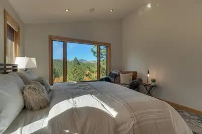 a bedroom with a large bed and a large window at Pinnacle Views at Tahoe Donner - 4BR, Hot Tub in Truckee