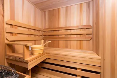 a sauna with wooden shelves and a bucket in it at Overlook Lake View Lodge by Tahoe Getaways- Dog Friendly, HOA, Sauna, Hot Tub, Views of Donner Lake in Truckee