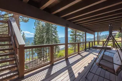 a hammock on a deck with a view at Overlook Lake View Lodge by Tahoe Getaways- Dog Friendly, HOA, Sauna, Hot Tub, Views of Donner Lake in Truckee