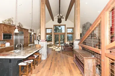 a large kitchen with wooden floors and wooden beams at Overlook Lake View Lodge by Tahoe Getaways- Dog Friendly, HOA, Sauna, Hot Tub, Views of Donner Lake in Truckee