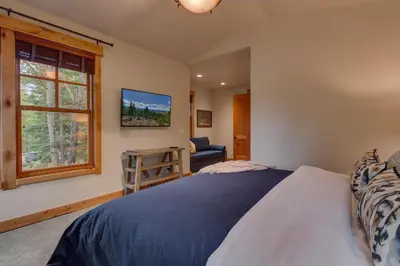 a bedroom with a bed and a window at Pine Meadow at Gray's Crossing - 4BR w Two Master Suites in Truckee