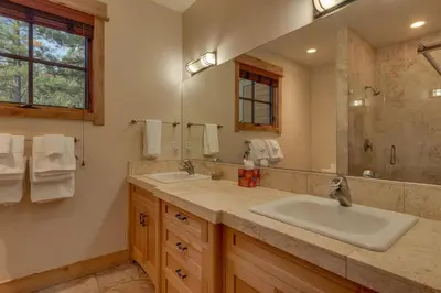 a bathroom with two sinks and a large mirror at Pine Meadow at Gray's Crossing - 4BR w Two Master Suites in Truckee