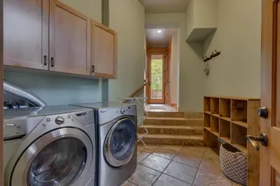 a laundry room with a washer and dryer at Pine Meadow at Gray's Crossing - 4BR w Two Master Suites in Truckee