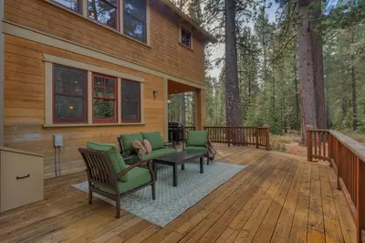 a wooden deck with a table and chairs on it at Pine Meadow at Gray's Crossing - 4BR w Two Master Suites in Truckee