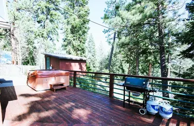 a deck with a tub and a grill on it at Pioneer Lake View- 4BR Easy Walk to Town Private Hot Tub - Sleeps 11 in Tahoe City