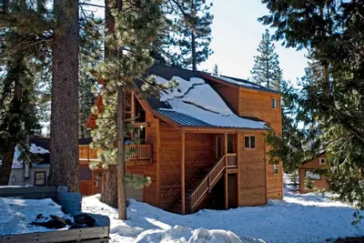 a log cabin in the woods in the snow at Red Cedar on North Shore - Beautiful 3BR w Gorgeous Furnishings in Tahoe City in Tahoe City
