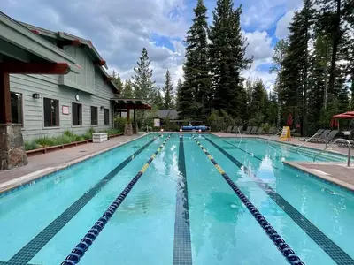 a large swimming pool with blue water at Ponderosa Pines - Custom 3 BR - Pet Friendly Private Hot Tub - Ski Shuttle in Truckee