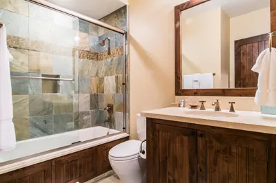 a bathroom with a toilet and a shower and a sink at Village Walk - Private Hot Tub, HOA Amenities, Pet Friendly, Walk to Lifts! in Truckee