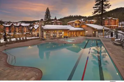 a large swimming pool in front of a resort at Village Walk - Private Hot Tub, HOA Amenities, Pet Friendly, Walk to Lifts! in Truckee