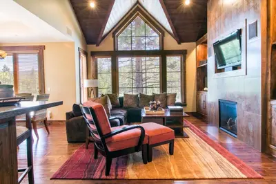 a living room with a couch and a table at Village Walk - Private Hot Tub, HOA Amenities, Pet Friendly, Walk to Lifts! in Truckee