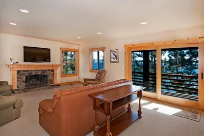 a living room with a couch and a fireplace at Water's Edge Lakefront- Buoy, Private Pier in Tahoe City