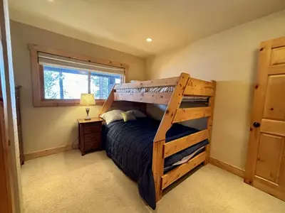 a bedroom with a bunk bed with a ladder at Water's Edge Lakefront- Buoy, Private Pier in Tahoe City