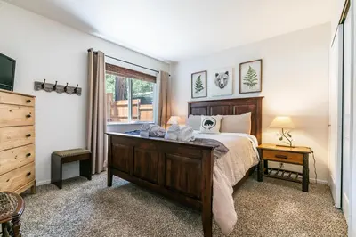 a bedroom with a large bed and a window at Wolf Den - Bright Open Concept 3 Bedroom- Hot Tub, Pet-Friendly, Minutes from Skiing! in Tahoma