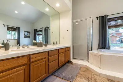 a bathroom with two sinks and a shower at Wolf Den - Bright Open Concept 3 Bedroom- Hot Tub, Pet-Friendly, Minutes from Skiing! in Tahoma