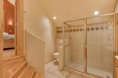 a bathroom with a shower and a toilet at West Pine Cabin on the West Shore by Tahoe Getaways - 2 BR w 2 Bonus Rooms, Hot Tub, Pool Table & Pet Friendly in Tahoe City