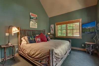 a bedroom with a bed with a wooden frame at New Listing! West Shore Bliss - 4BR, Private Hot Tub in Tahoe City