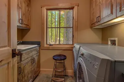 a laundry room with a washing machine and a window at New Listing! West Shore Bliss - 4BR, Private Hot Tub in Tahoe City