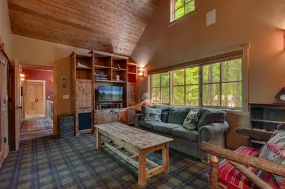a living room with a couch and a table at New Listing! West Shore Bliss - 4BR, Private Hot Tub in Tahoe City