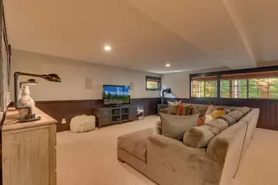 a living room with a couch and a flat screen tv at Woodcrest at Tahoe Donner 3BR with Pool Table - 3000 sq ft in Truckee