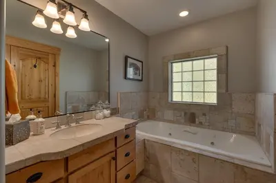 a bathroom with a tub and a sink and a bath tub at Woodcrest at Tahoe Donner 3BR with Pool Table - 3000 sq ft in Truckee