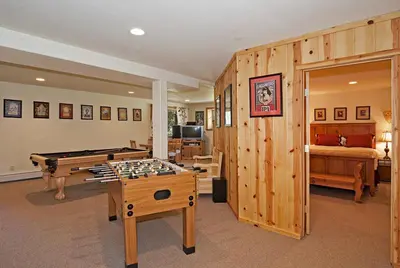 a living room with a pool table and a bedroom at Woodside Lodge on West Shore with Private Hot Tub, Pool Table & Game Room in Tahoma
