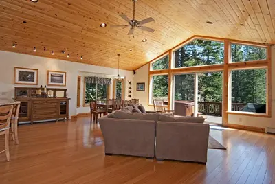 a large living room with a couch and a table at Woodside Lodge on West Shore with Private Hot Tub, Pool Table & Game Room in Tahoma