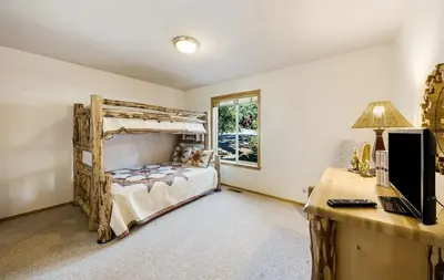 a bedroom with a bed and a desk with a computer at New Listing! Woodland Heights at Tahoe Park- Pet Friendly - Private Beach in Tahoe City