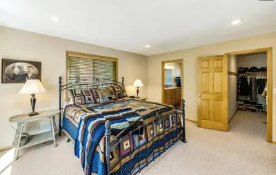 a bedroom with a bed and a table and a closet at New Listing! Woodland Heights at Tahoe Park- Pet Friendly - Private Beach in Tahoe City