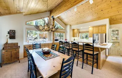 a kitchen with a large wooden table and chairs at New Listing! Woodland Heights at Tahoe Park- Pet Friendly - Private Beach in Tahoe City